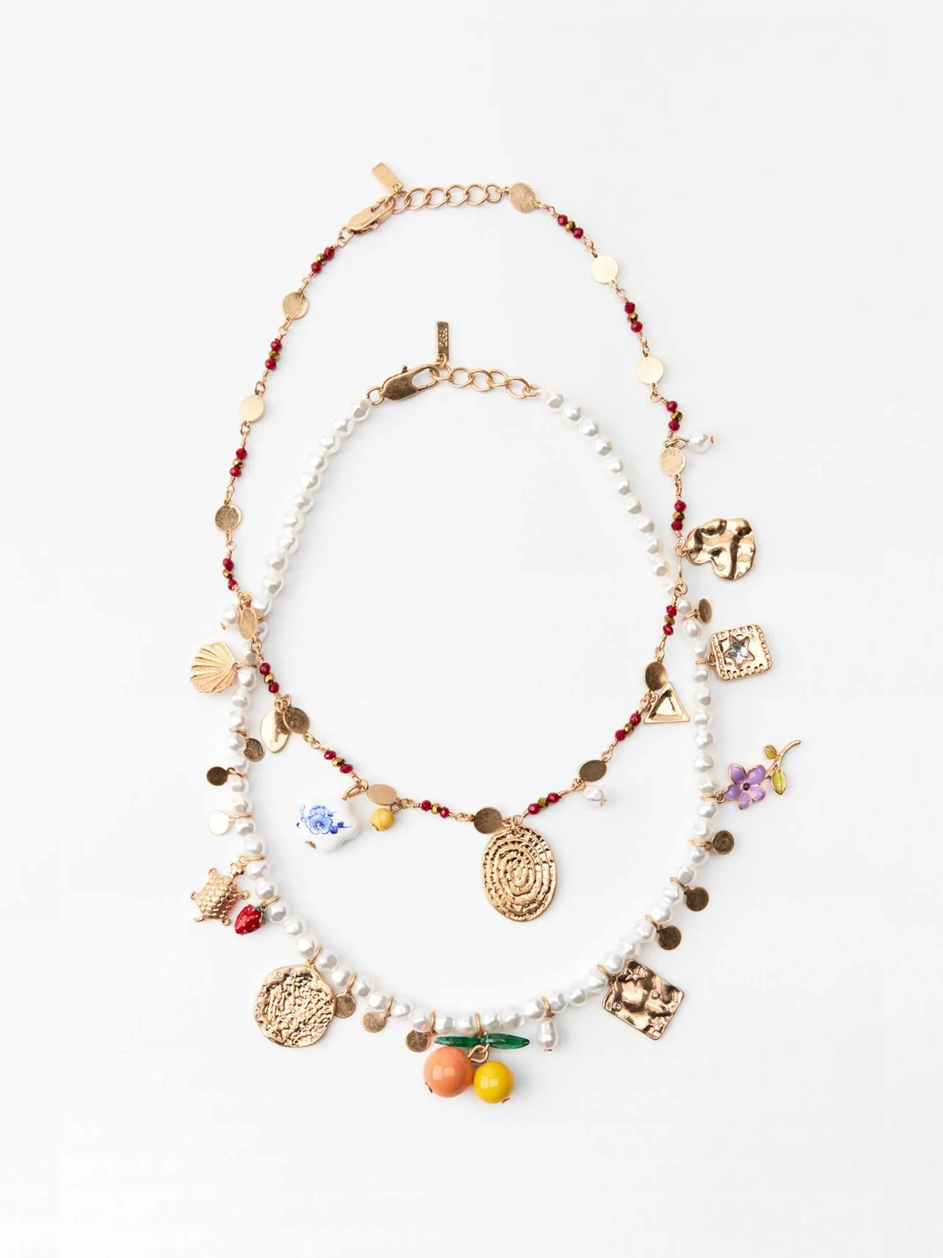 Pack of faux pearl and beaded necklaces with charms