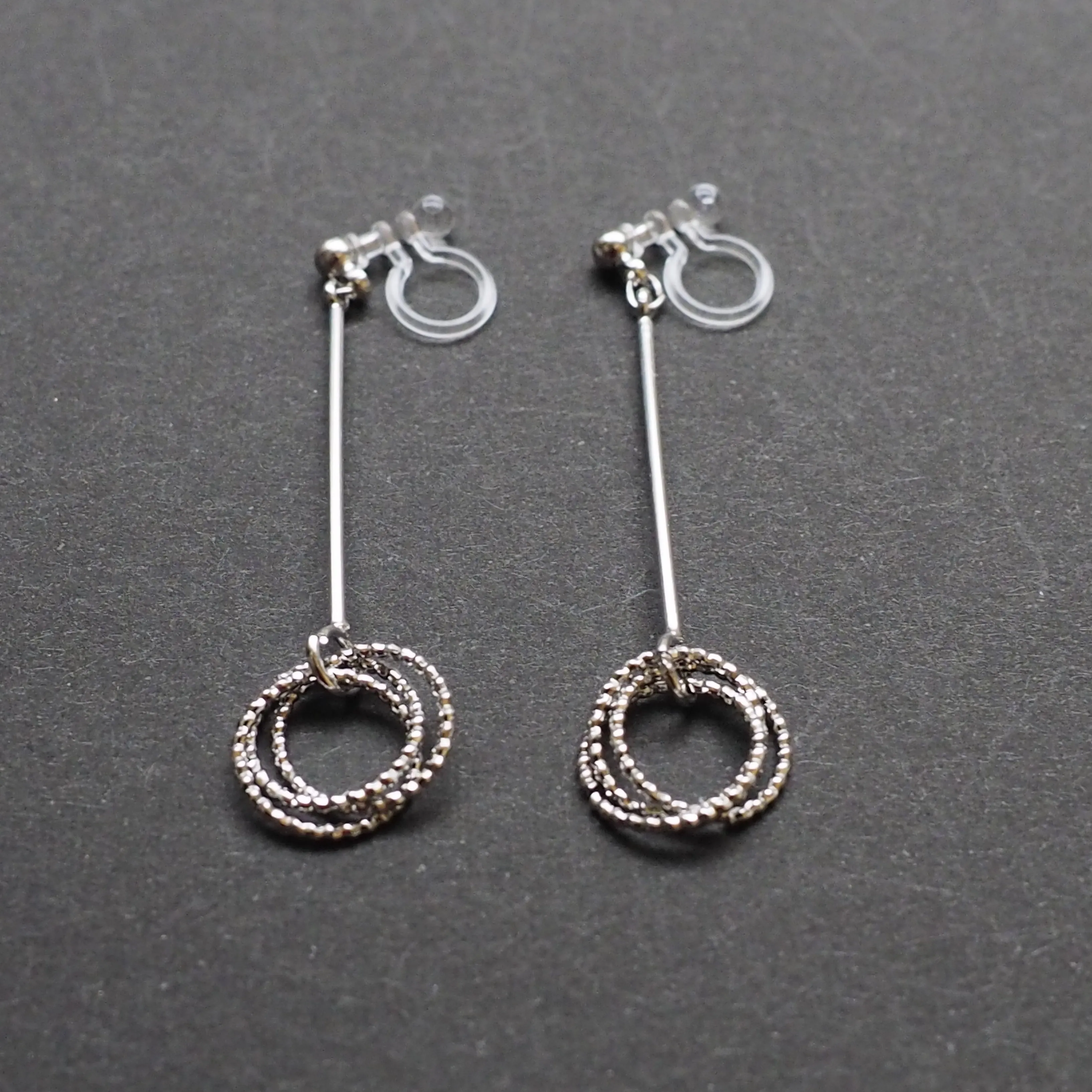 Textured triple hoop clip on earrings ( Silver tone )