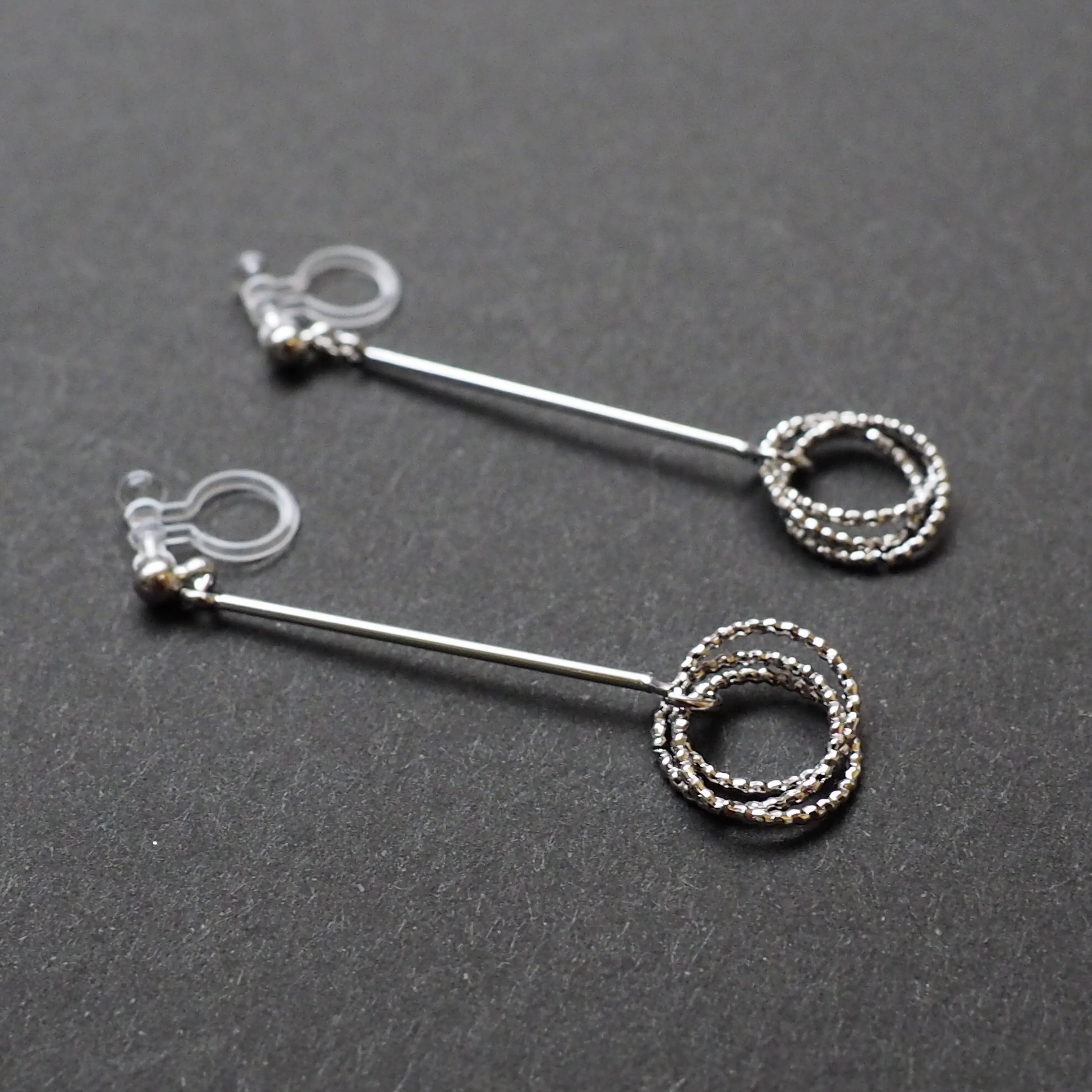 Textured triple hoop clip on earrings ( Silver tone )